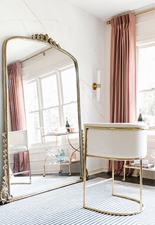 stylish chair next to large floor-length mirror