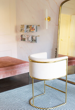 Beautiful Studio with Floor Length Gold Mirror and Cream Colored Velvet Designer Chair and Tufted Pink Velvet Ottoman