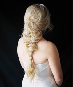 Blonde Model with long fishtail braids loosely pulled together