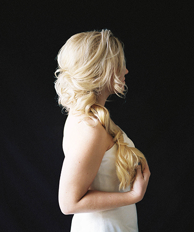 Blonde Model shot from side long fishtail braids loosely pulled together