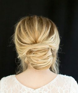 Blonde model with rounded bun and slight bouffant